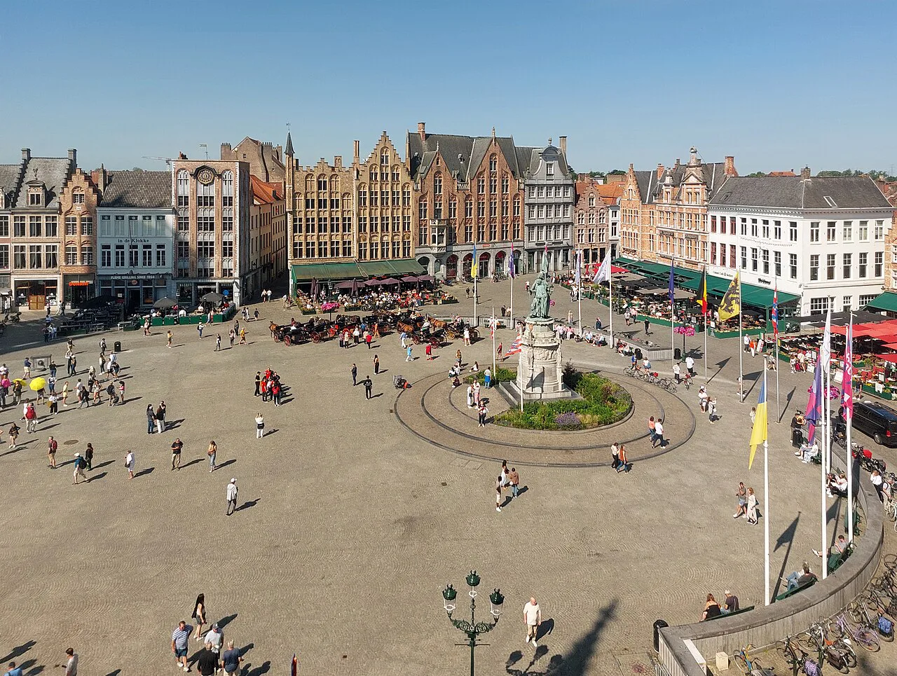 The Markt in Bruges, with its central monument and rows of gabled guildhouses.