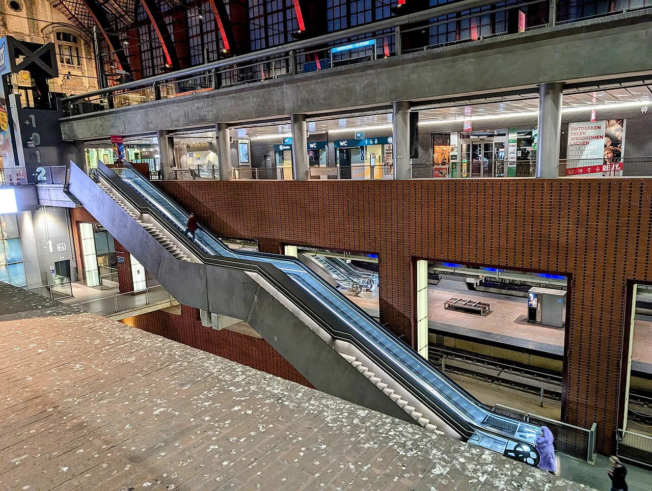 Escalators and platform levels inside Antwerp Central Station.