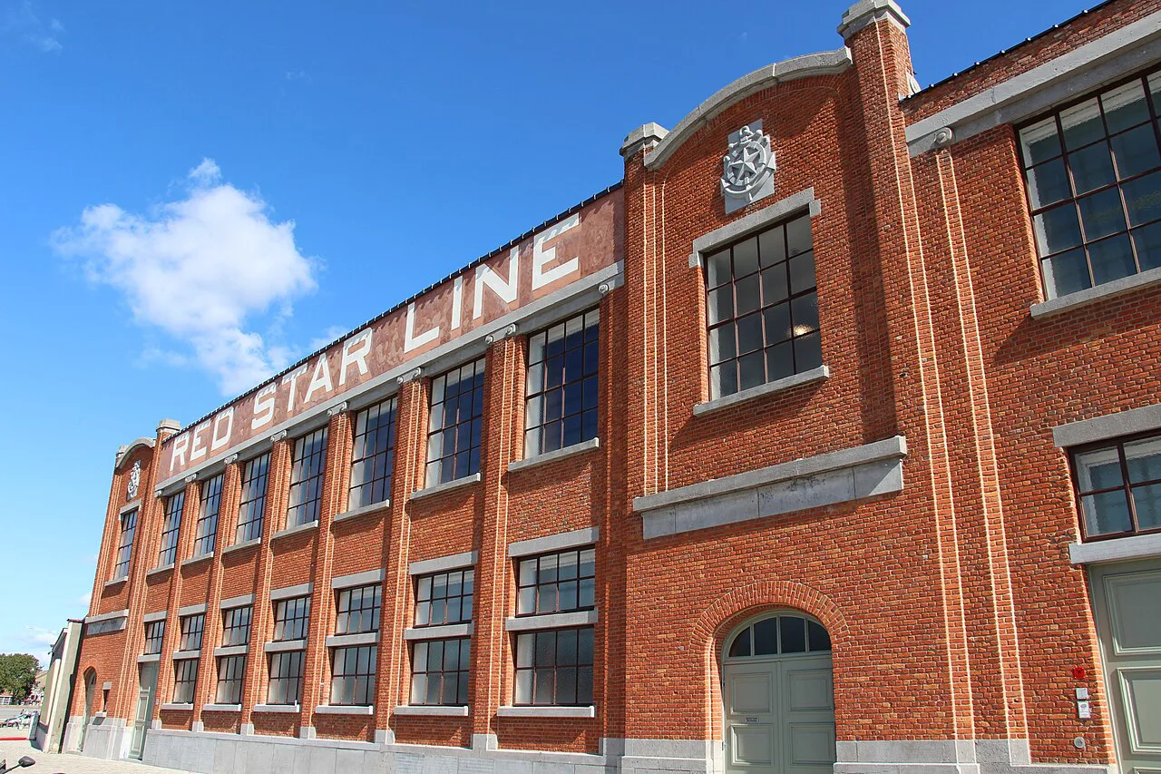 The red-brick Red Star Line Museum in Antwerp under a summer sky.