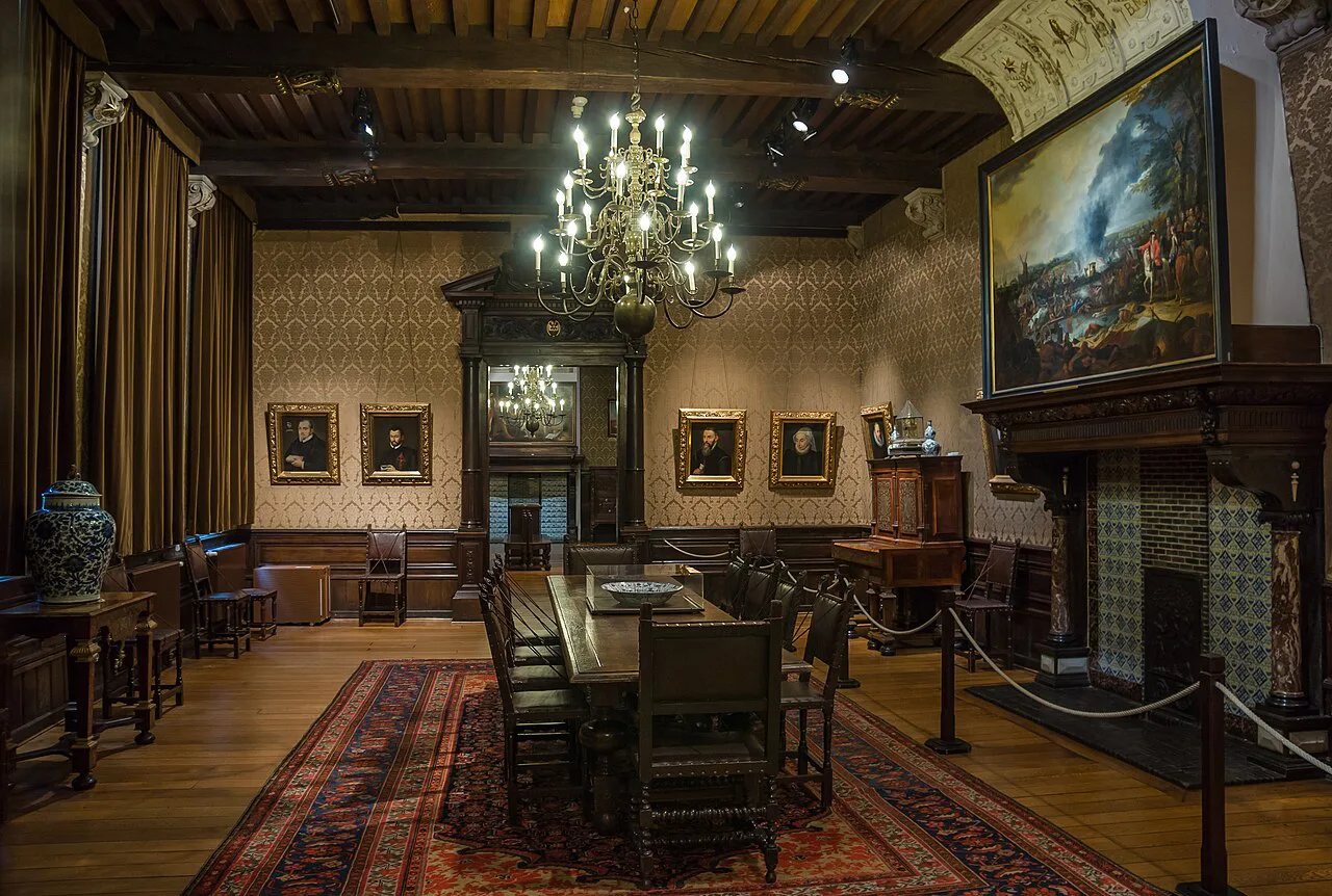 A furnished interior with paintings and a chandelier at the Plantin-Moretus Museum, Antwerp.