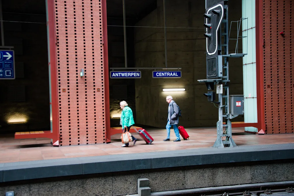 Travellers on a platform at Antwerp Central Station.