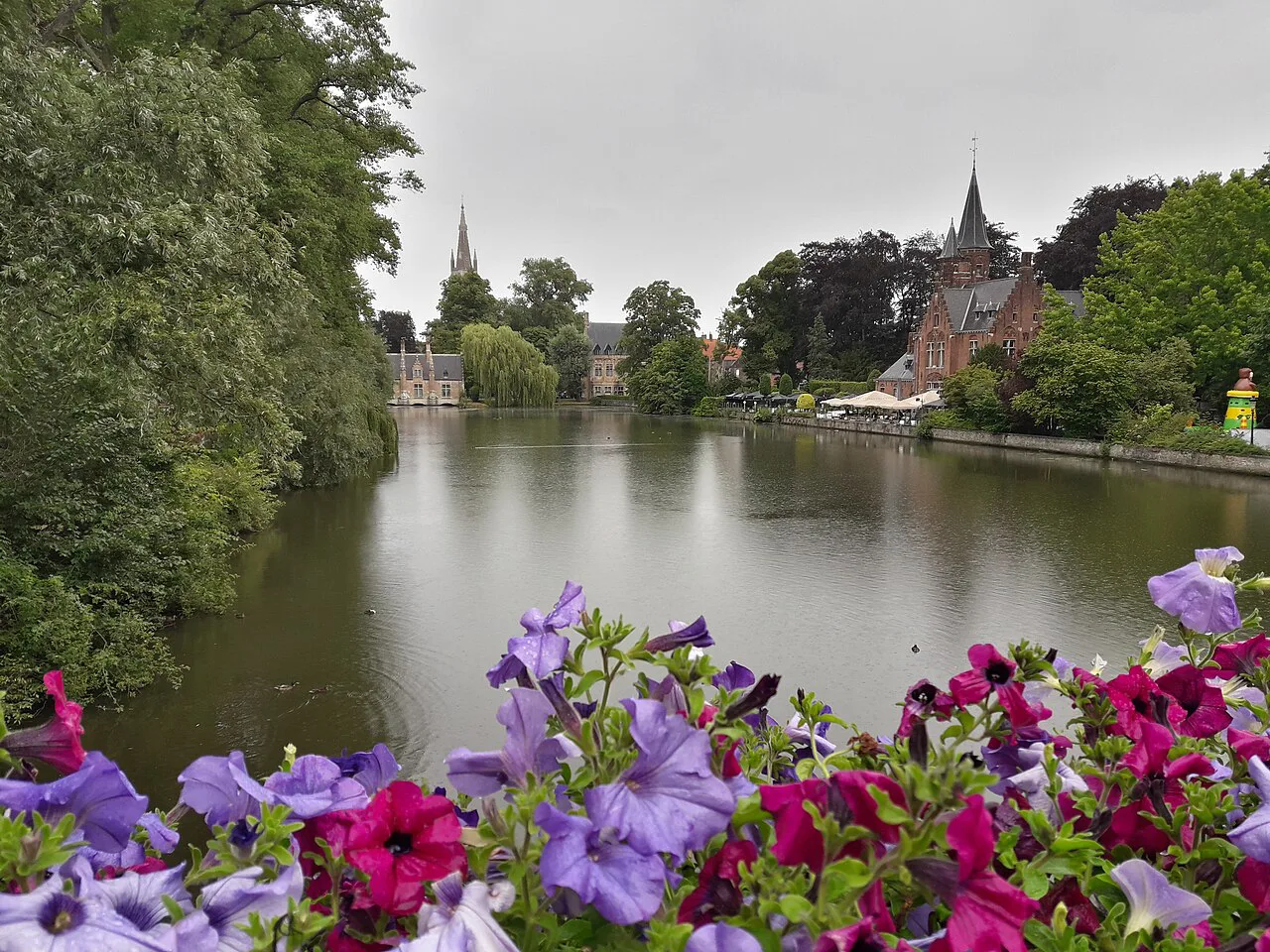 Flowers framing a view across the Minnewater lake, Bruges.