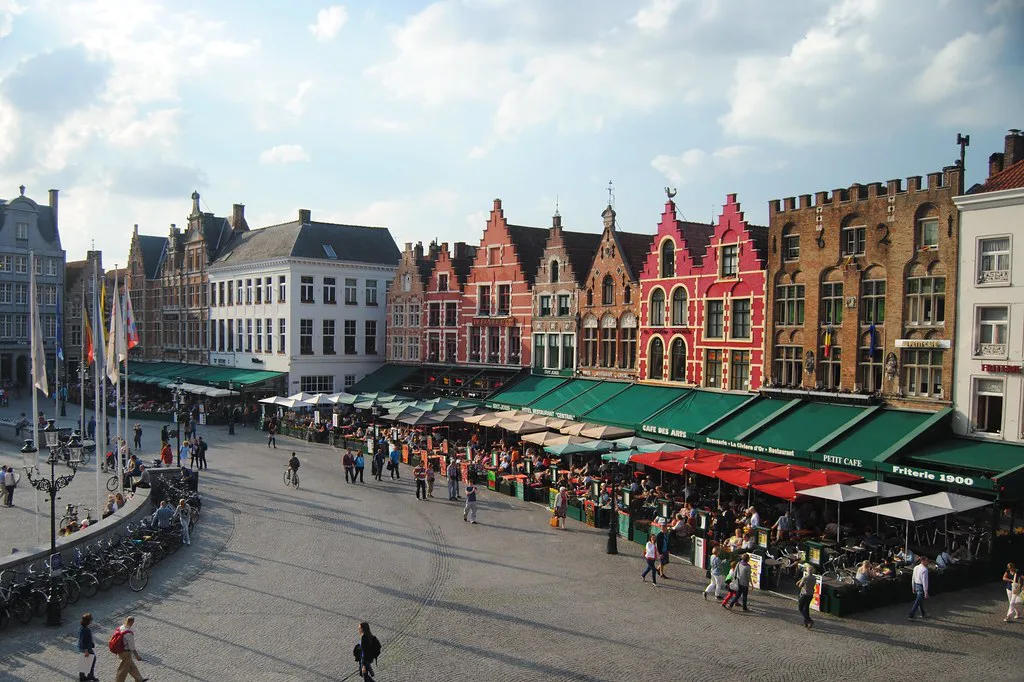 Café terraces in front of the gabled houses on the Markt in Bruges.