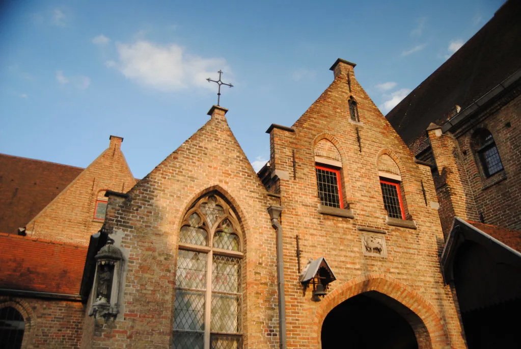 A Gothic brick gable glowing in low sun, Bruges.