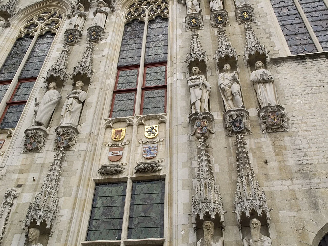 Statues and Gothic tracery on the façade of the town hall on the Burg, Bruges.