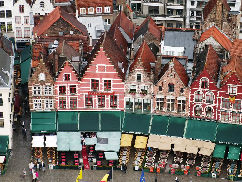Gabled guild houses and market stalls on the Markt, Bruges.