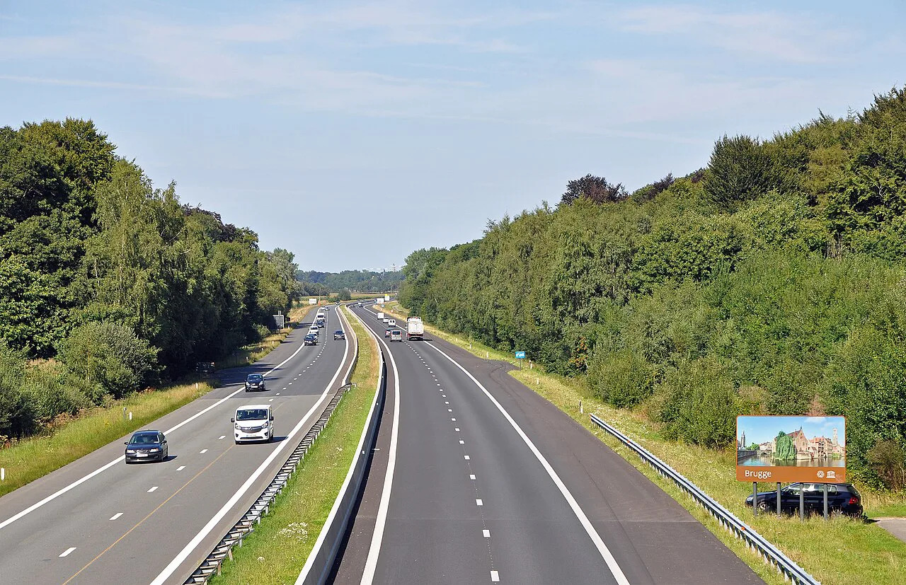 The A17 motorway through wooded countryside near Oostkamp.