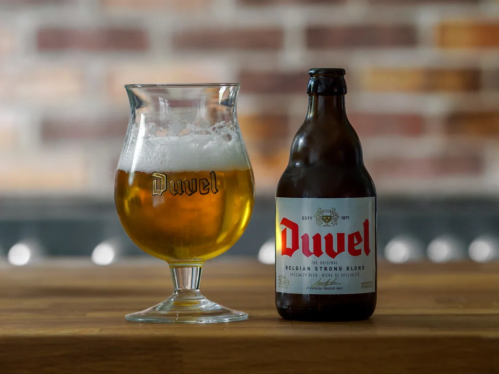 A glass and bottle of Duvel.