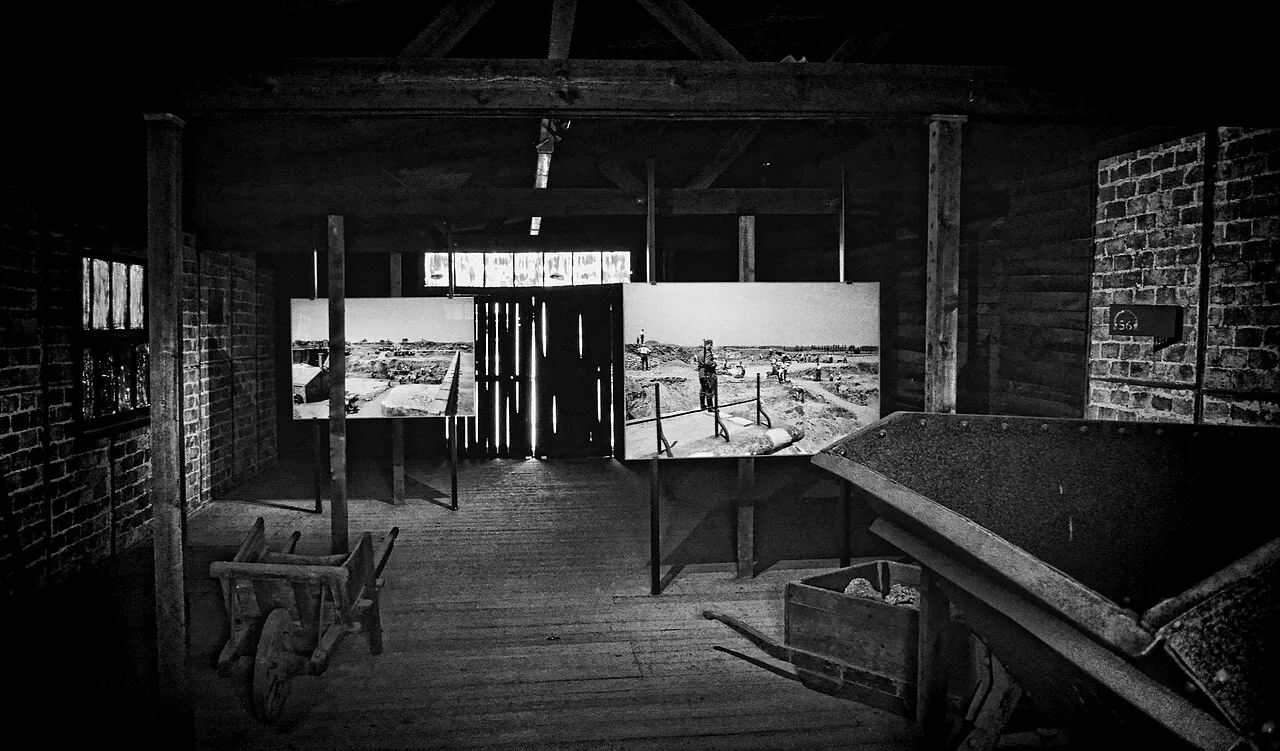 Photographic panels and wheelbarrows inside a former prisoners' barrack at Fort Breendonk, Willebroek.