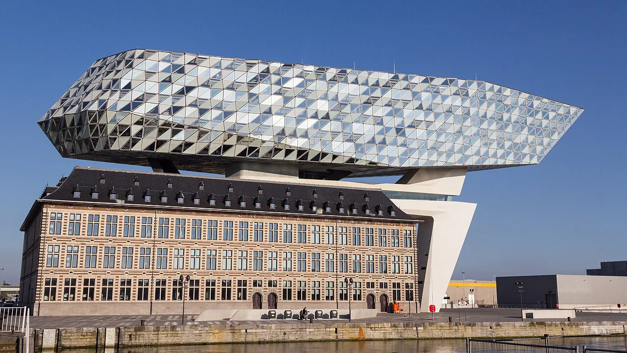 The Port House perched above its historic brick base, Antwerp.