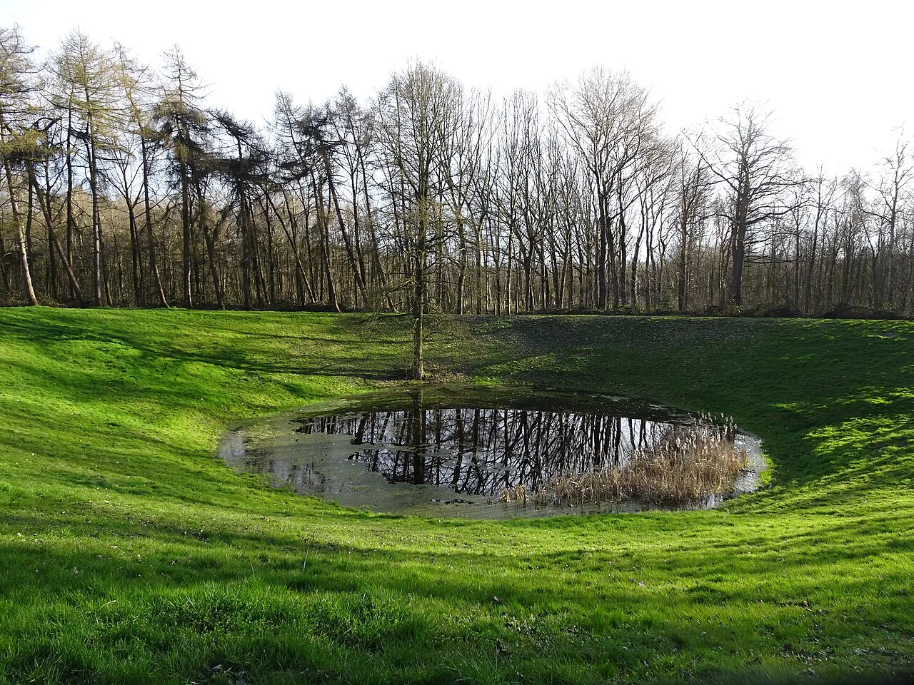 The flooded Caterpillar mine crater at the Hill 60 battlefield site, Zillebeke, near Ypres.
