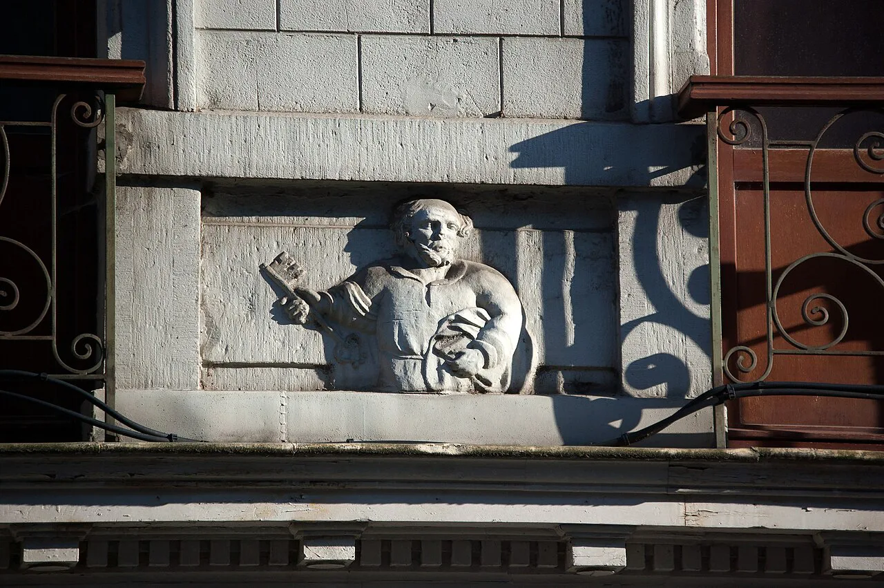 A carved figure of Saint Peter on a house front in the Rue Hors-Château, Liège.