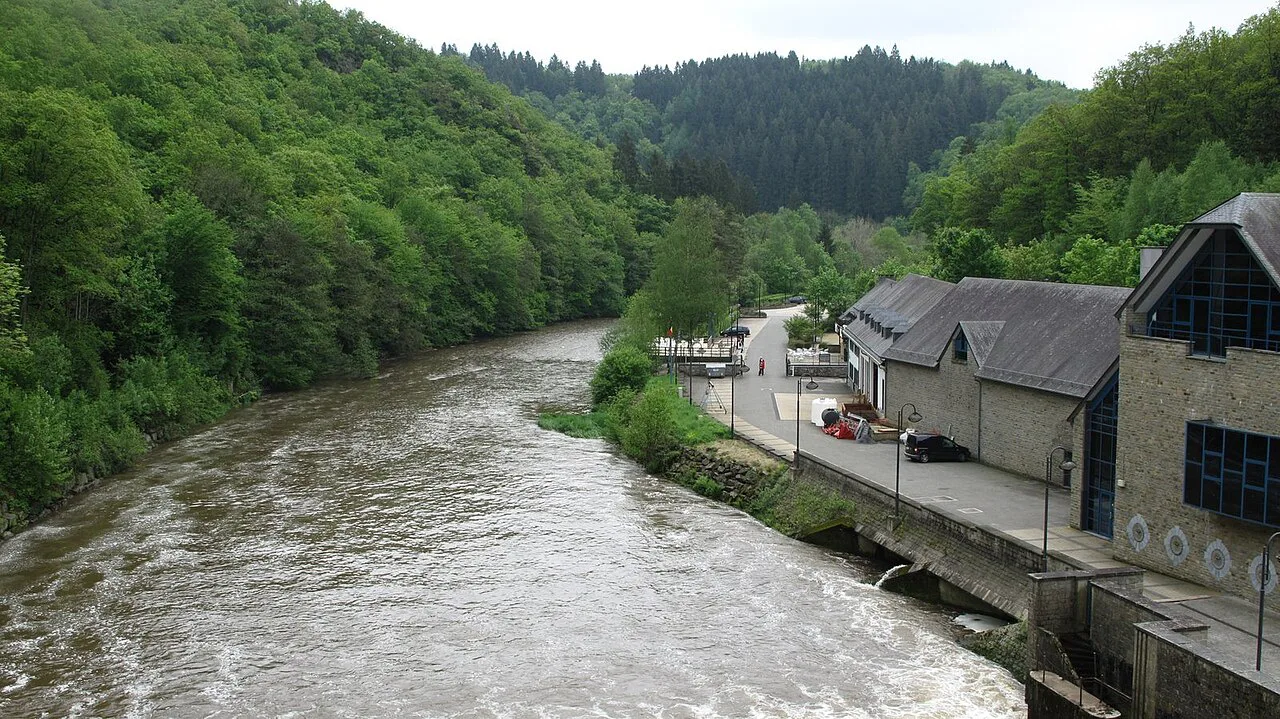 The River Ourthe flowing past riverside buildings in Houffalize.