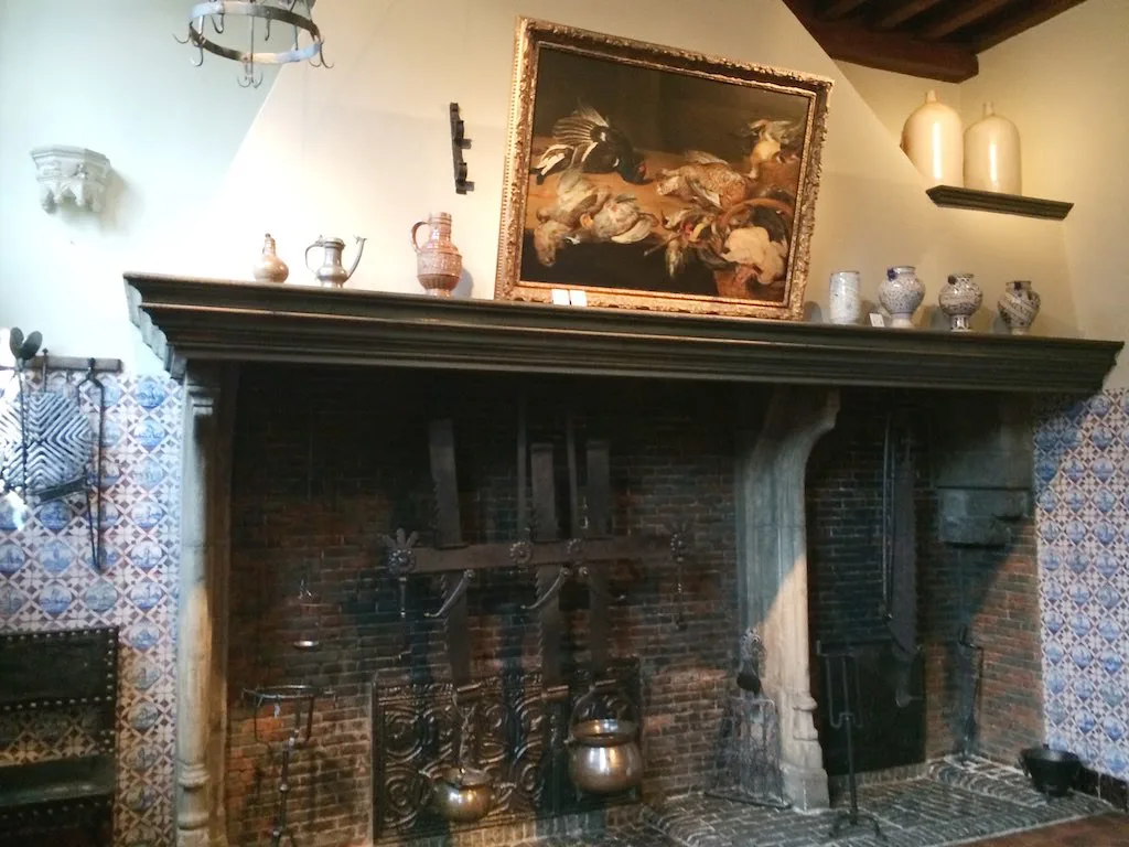 A period room with a fireplace inside the Rubens House, Antwerp.