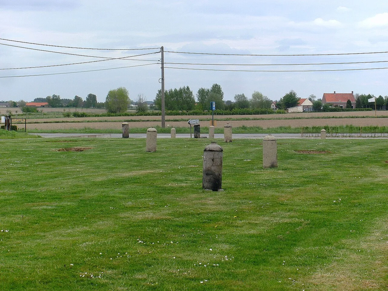 Replica gas cylinders lining the access road to the Langemark German War Cemetery, Langemark-Poelkapelle.