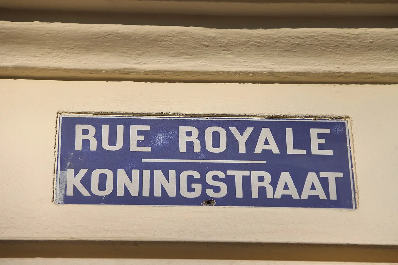 A bilingual French and Dutch street sign for Rue Royale and Koningstraat, Brussels.
