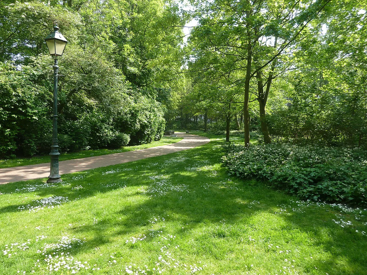 A tree-lined path across the lawns of Leopold Park in Ostend.
