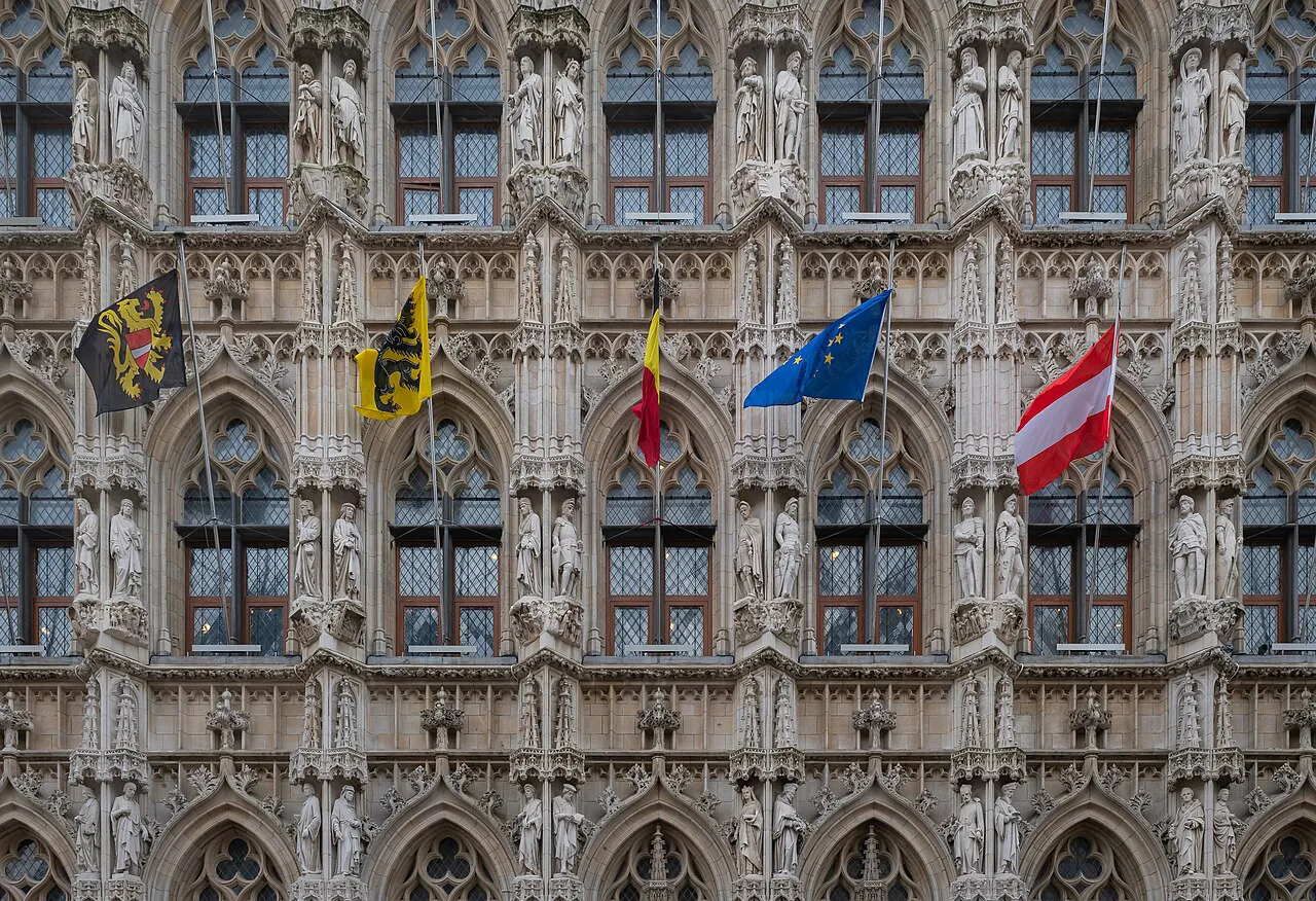 Statues and Gothic windows on the facade of Leuven Town Hall.