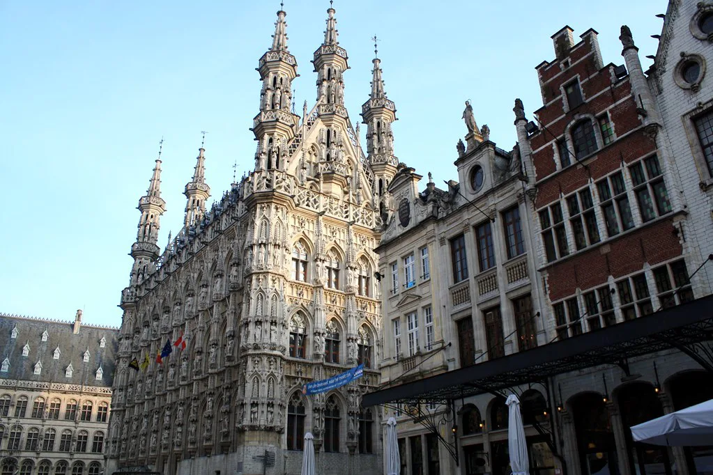 Leuven Town Hall beside neighbouring gabled houses.