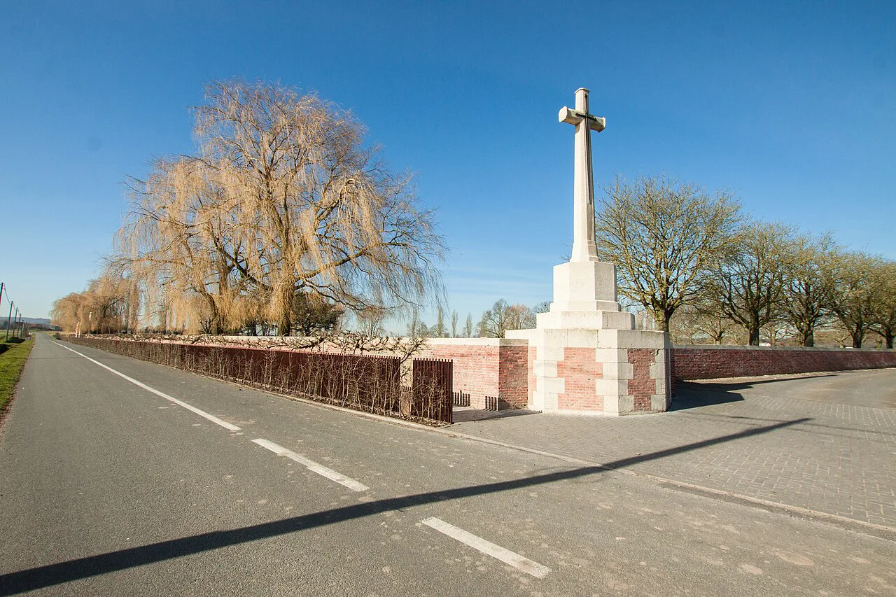 The Cross of Sacrifice seen from the road at Lijssenthoek Military Cemetery, Poperinge.