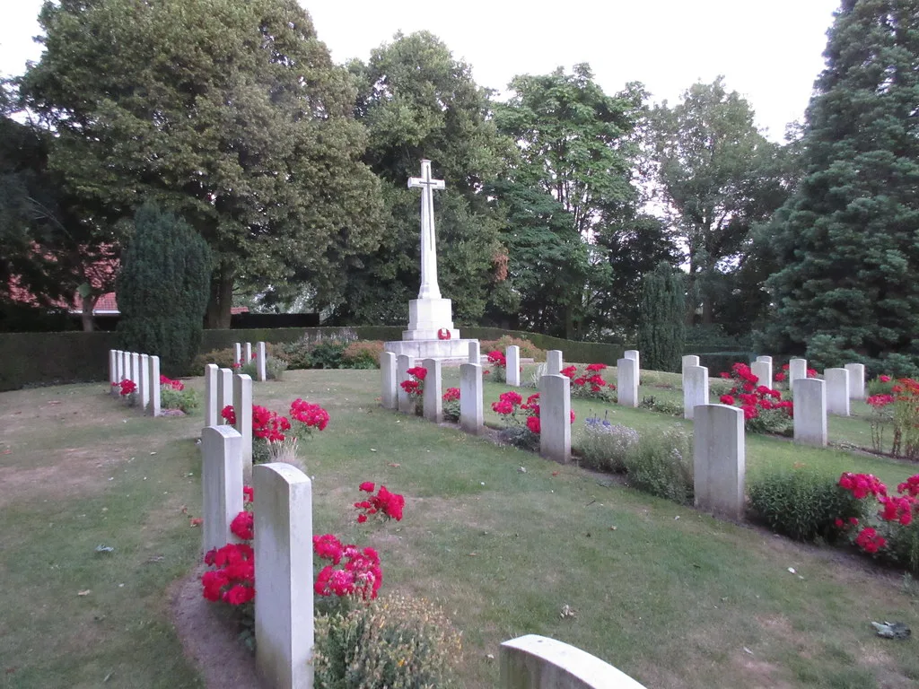 The Cross of Sacrifice and headstones at the Ramparts War Cemetery in Ypres.