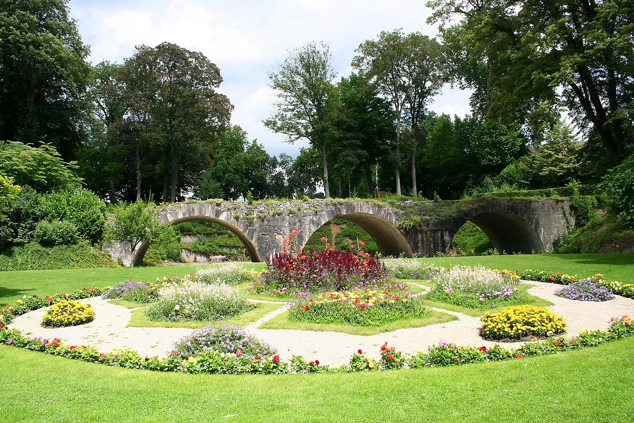 Flowerbeds and the remains of an old stone bridge in Louise-Marie Park, Namur.