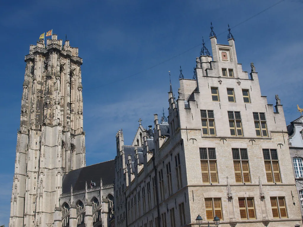 St Rumbold's Tower above gabled buildings in central Mechelen.