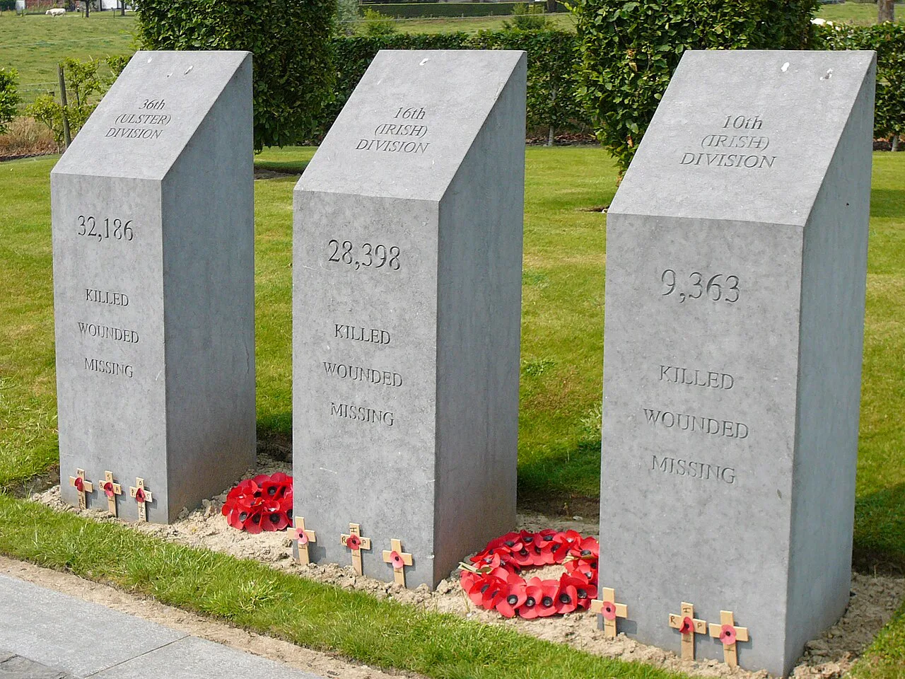 The three stone pillars honouring the Irish divisions at the Island of Ireland Peace Park, Mesen.