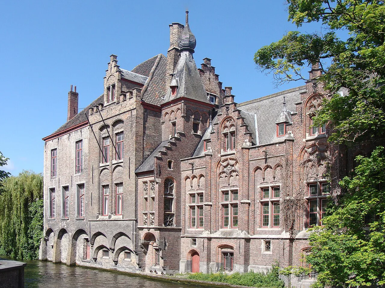 Old brick houses beside a canal in Bruges.