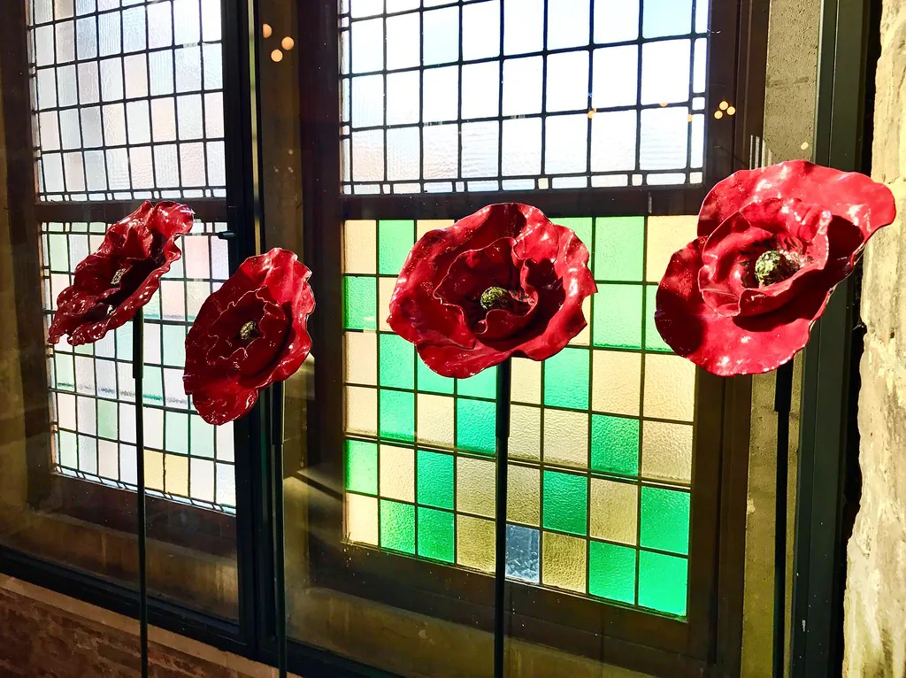 Red poppies displayed against a stained-glass window in the In Flanders Fields Museum in Ypres.