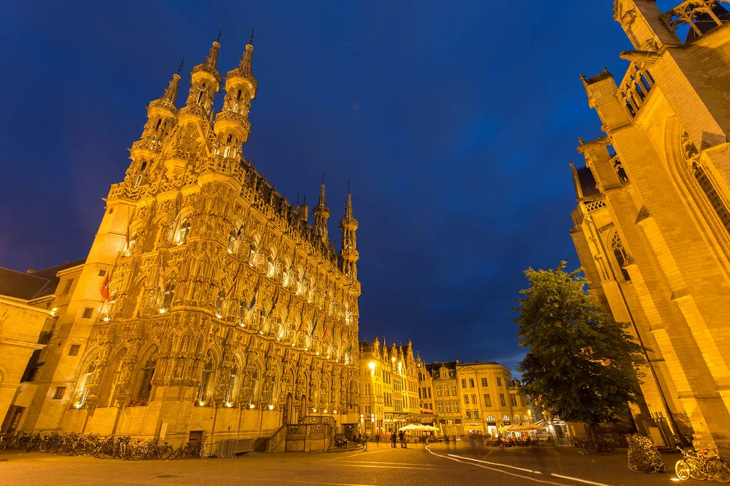 Leuven Town Hall illuminated at night.