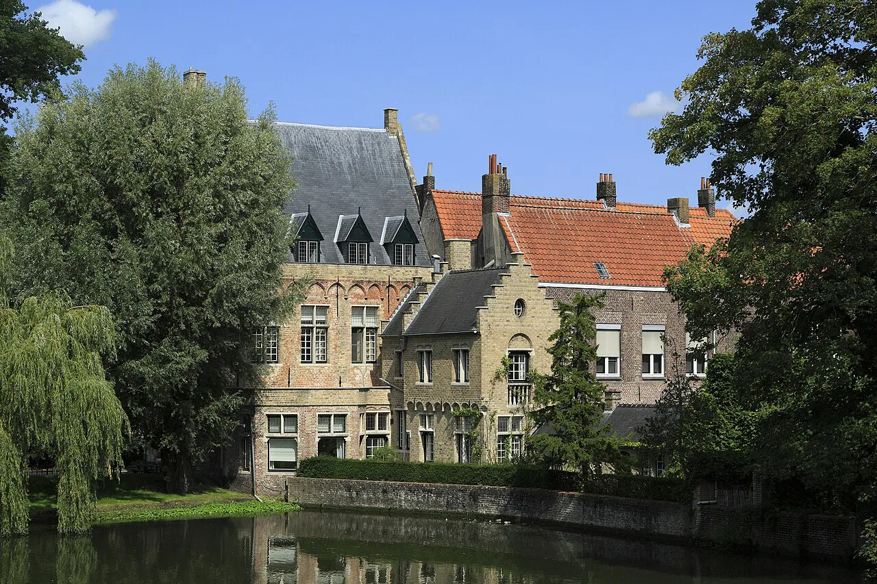 Houses along the Minnewater in Bruges, seen across the water.