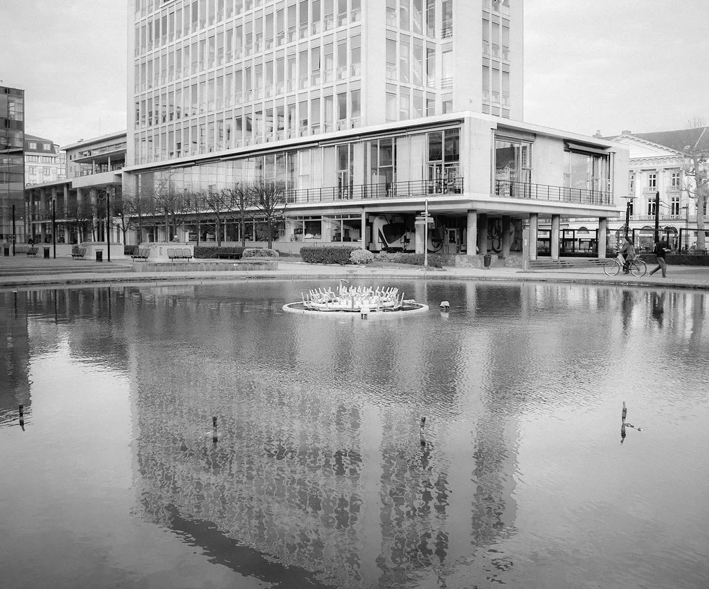 A pond reflecting modern buildings at the South Park in Ghent.