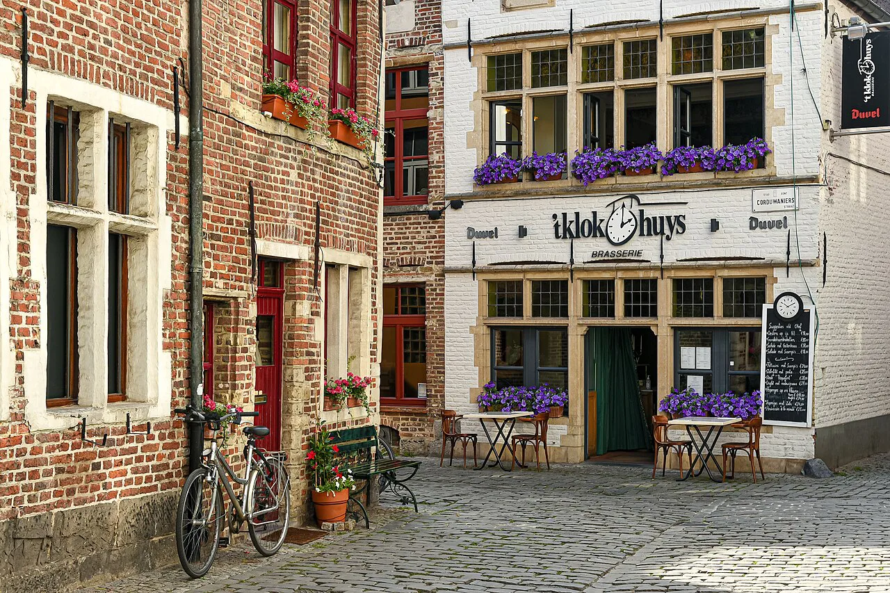 A cobbled street with brick houses and a café in the Patershol, Ghent.