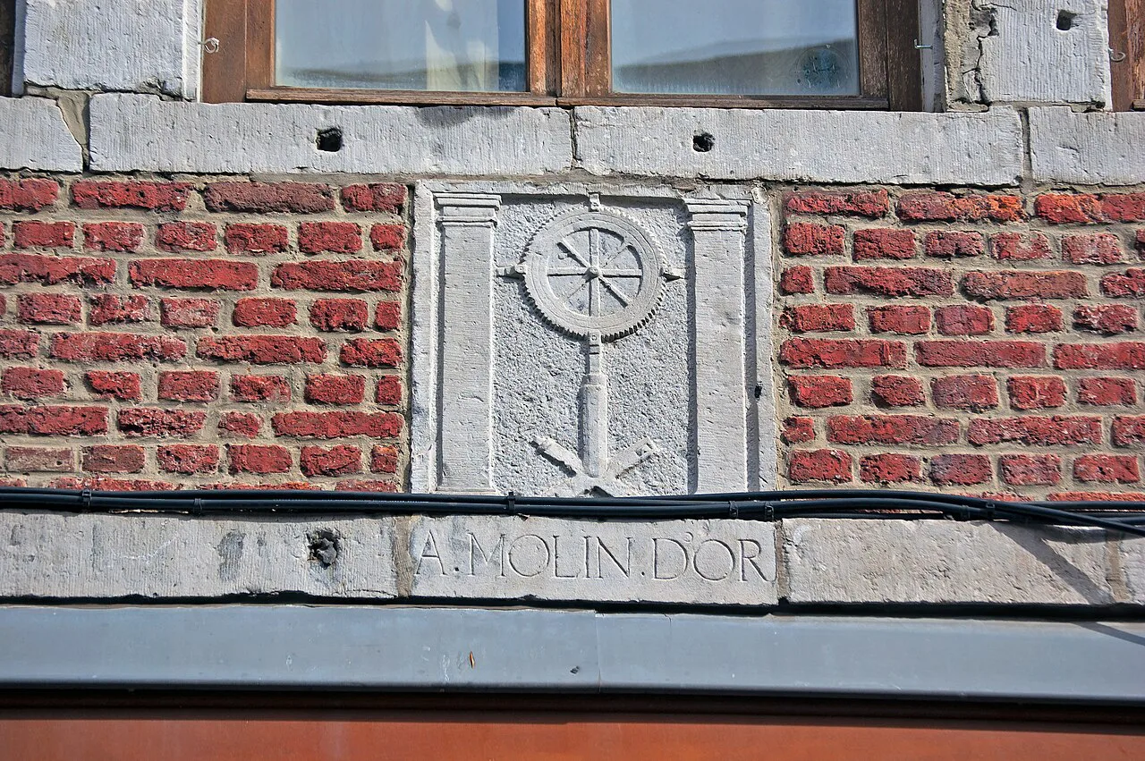 A carved house sign above a doorway on Rue Pierreuse, Liège.