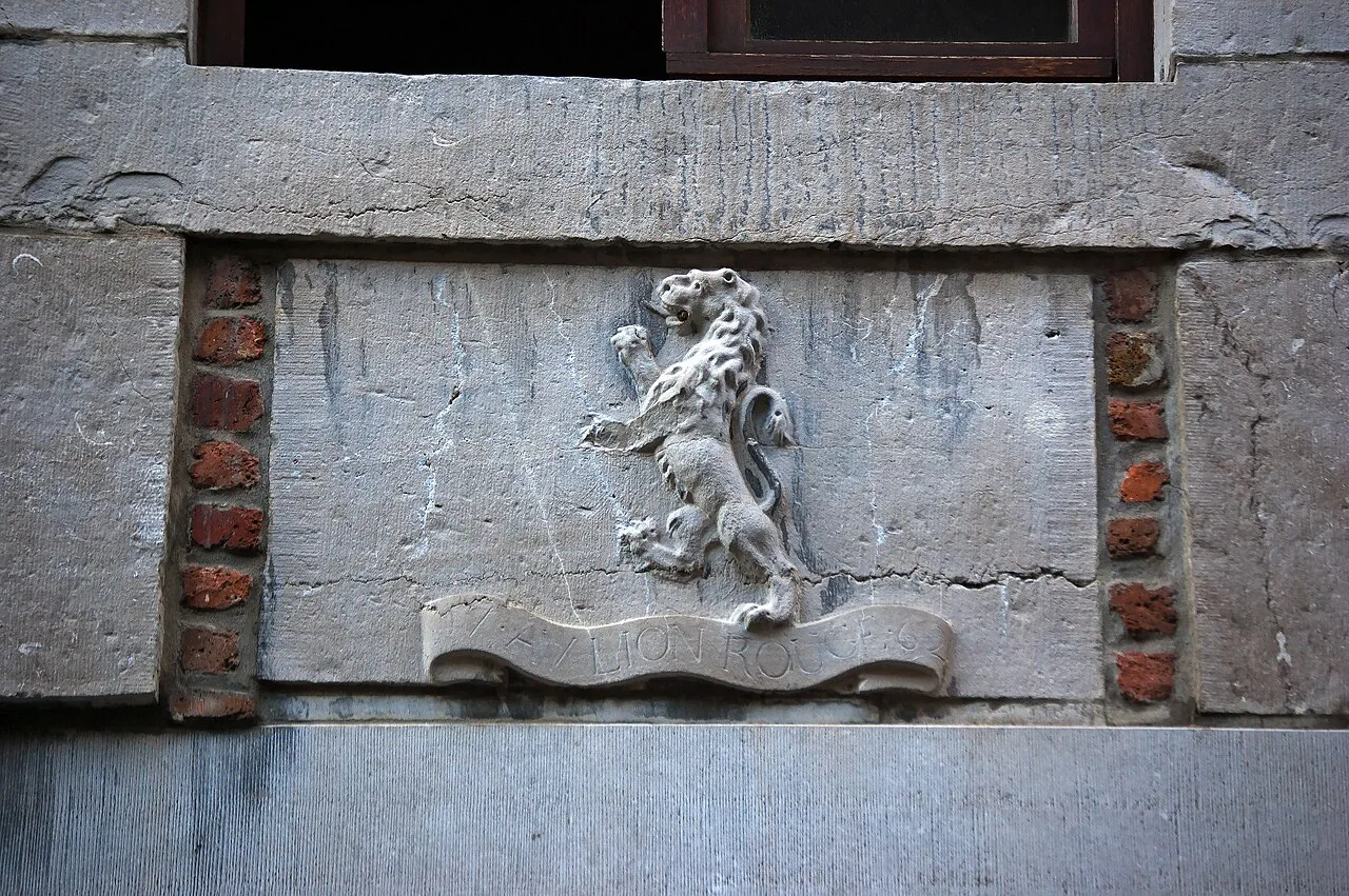 A carved lion house sign on a façade in Rue Pierreuse, Liège.