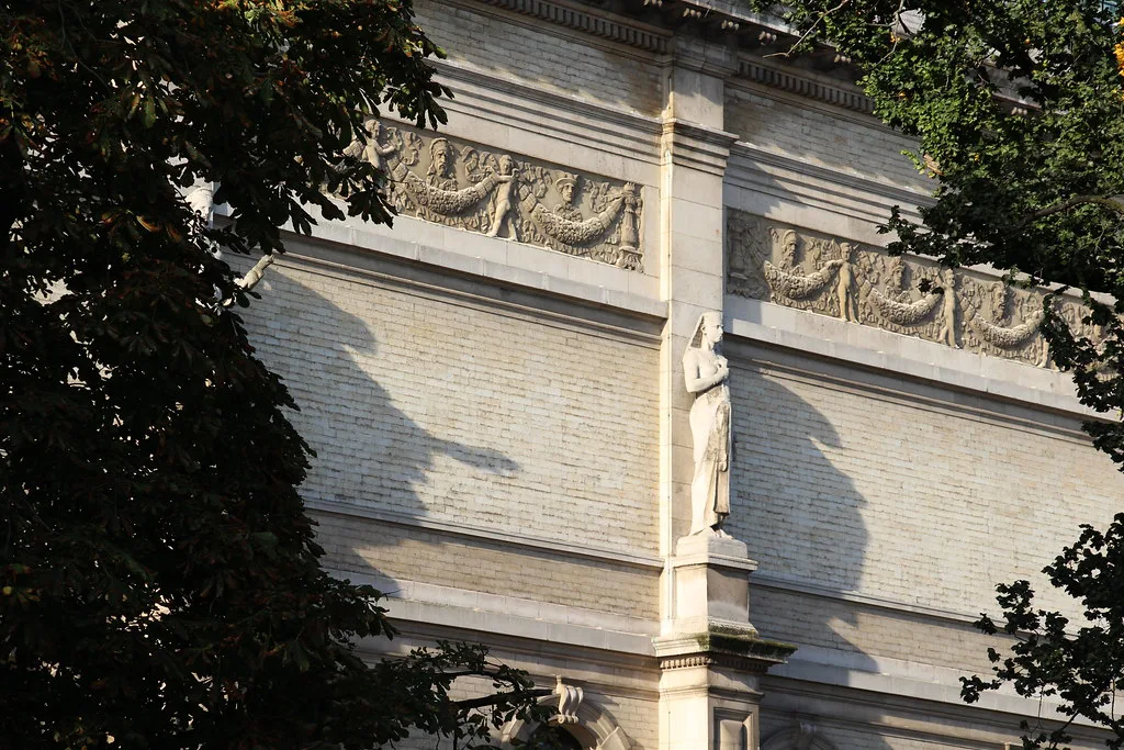 Sculpted friezes and a statue on the facade of the Royal Museum of Fine Arts Antwerp.