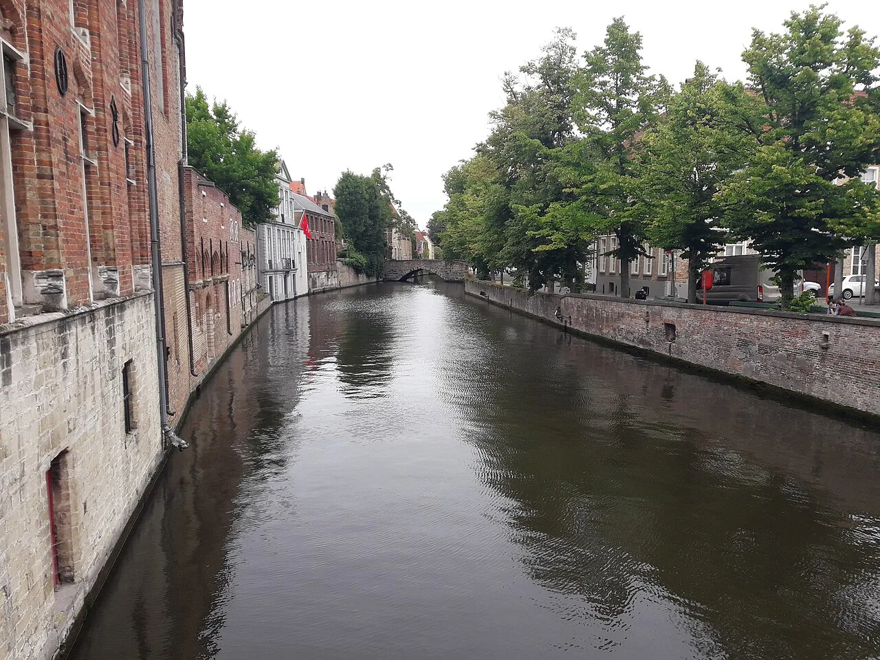 A quiet tree-lined canal in central Bruges.