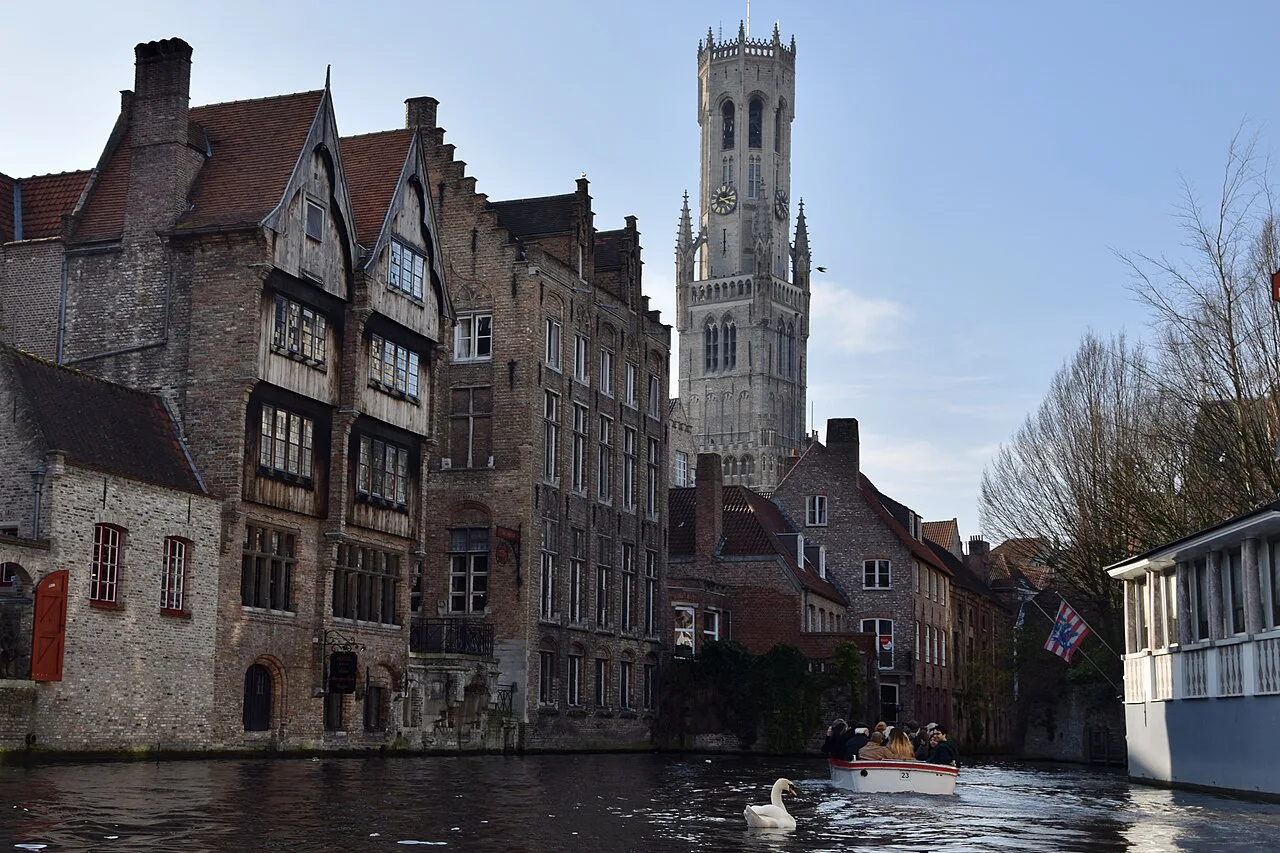 The Rozenhoedkaai canal with the Belfry of Bruges rising behind.