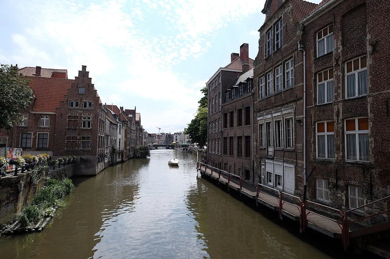 A canal lined with old brick houses in central Ghent.