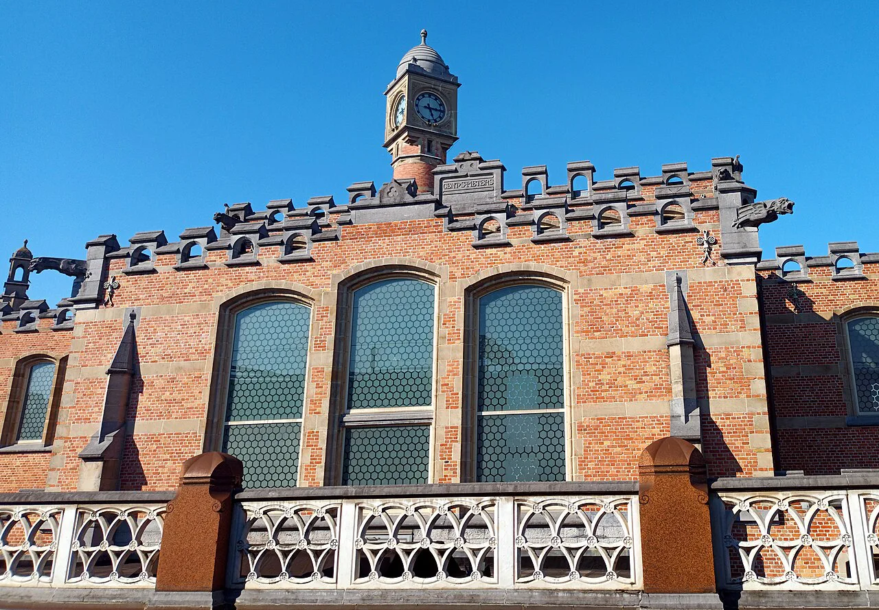 The ornate brick roofline of Gent-Sint-Pieters railway station, Ghent.