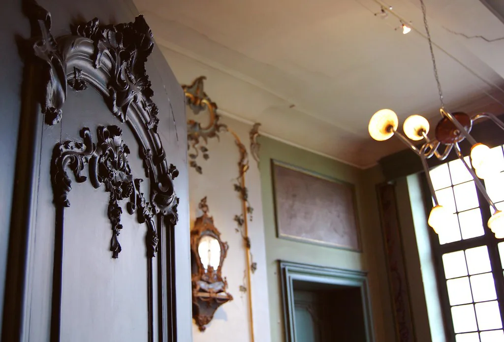 A carved door and rococo decoration in a period room of the Design Museum Gent.