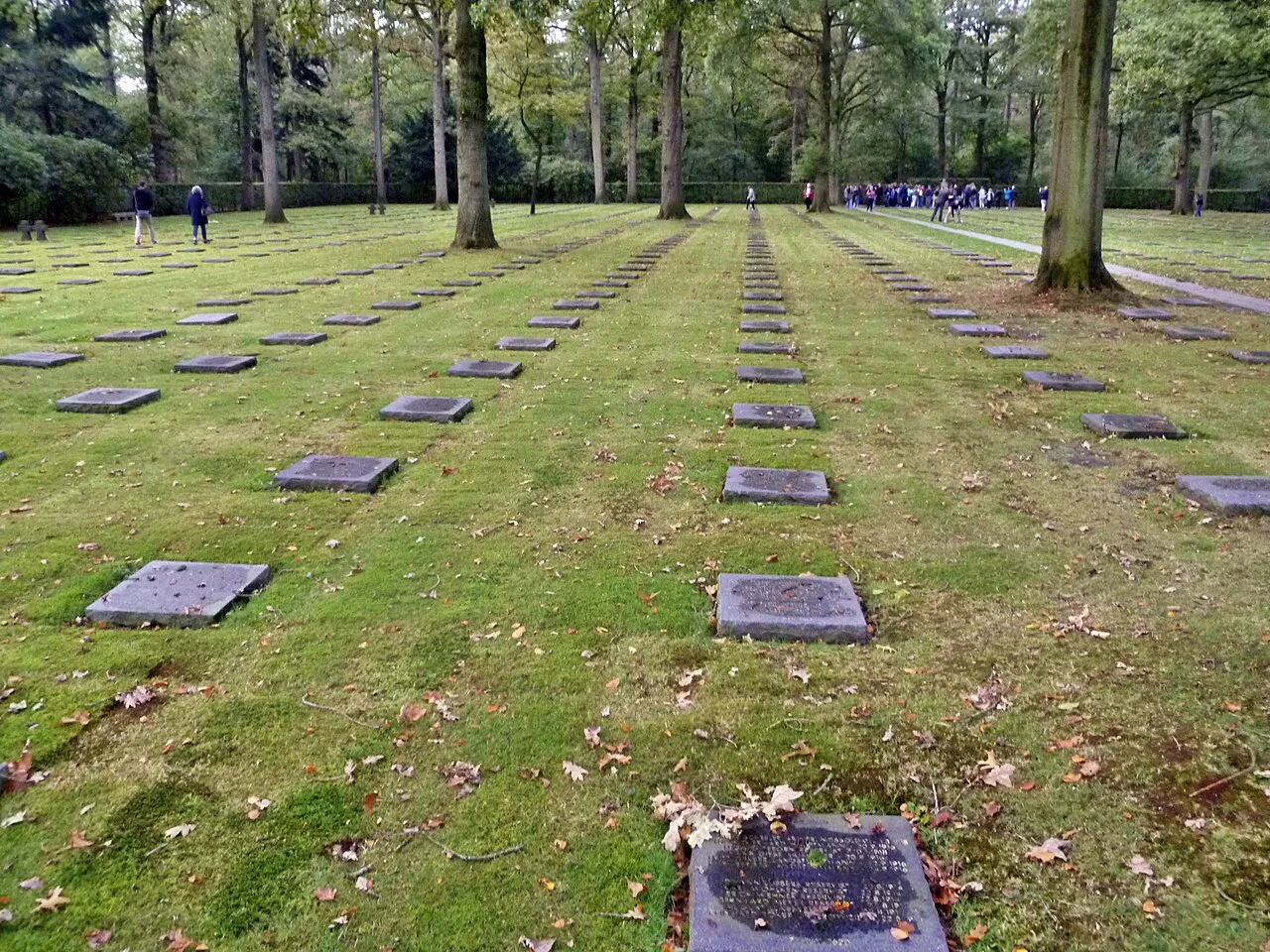Flat grave plaques in rows under the trees at Vladslo German Military Cemetery, Diksmuide.