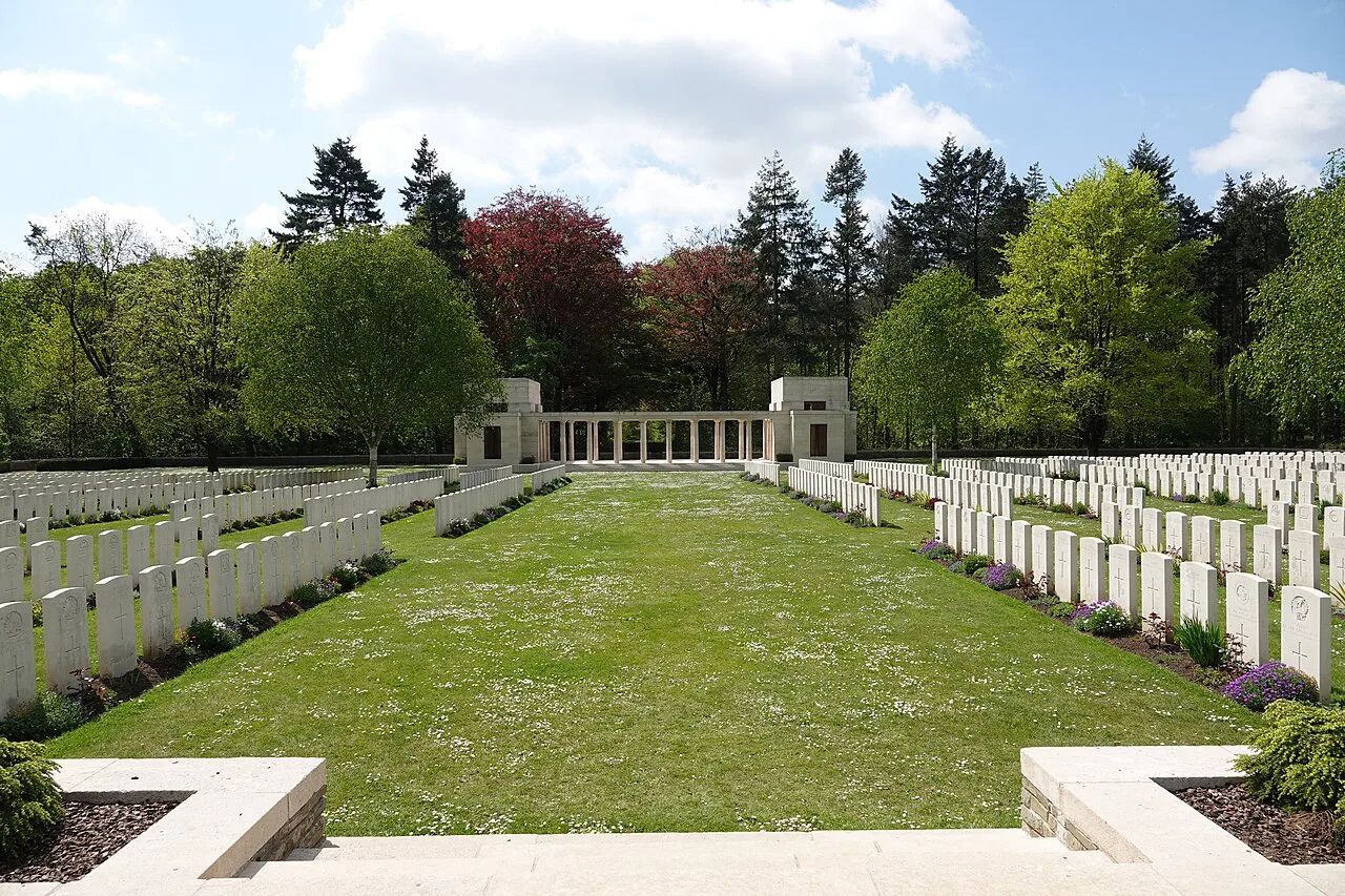 The lawn and headstone rows leading to the memorial at Buttes New British Cemetery, Zonnebeke.